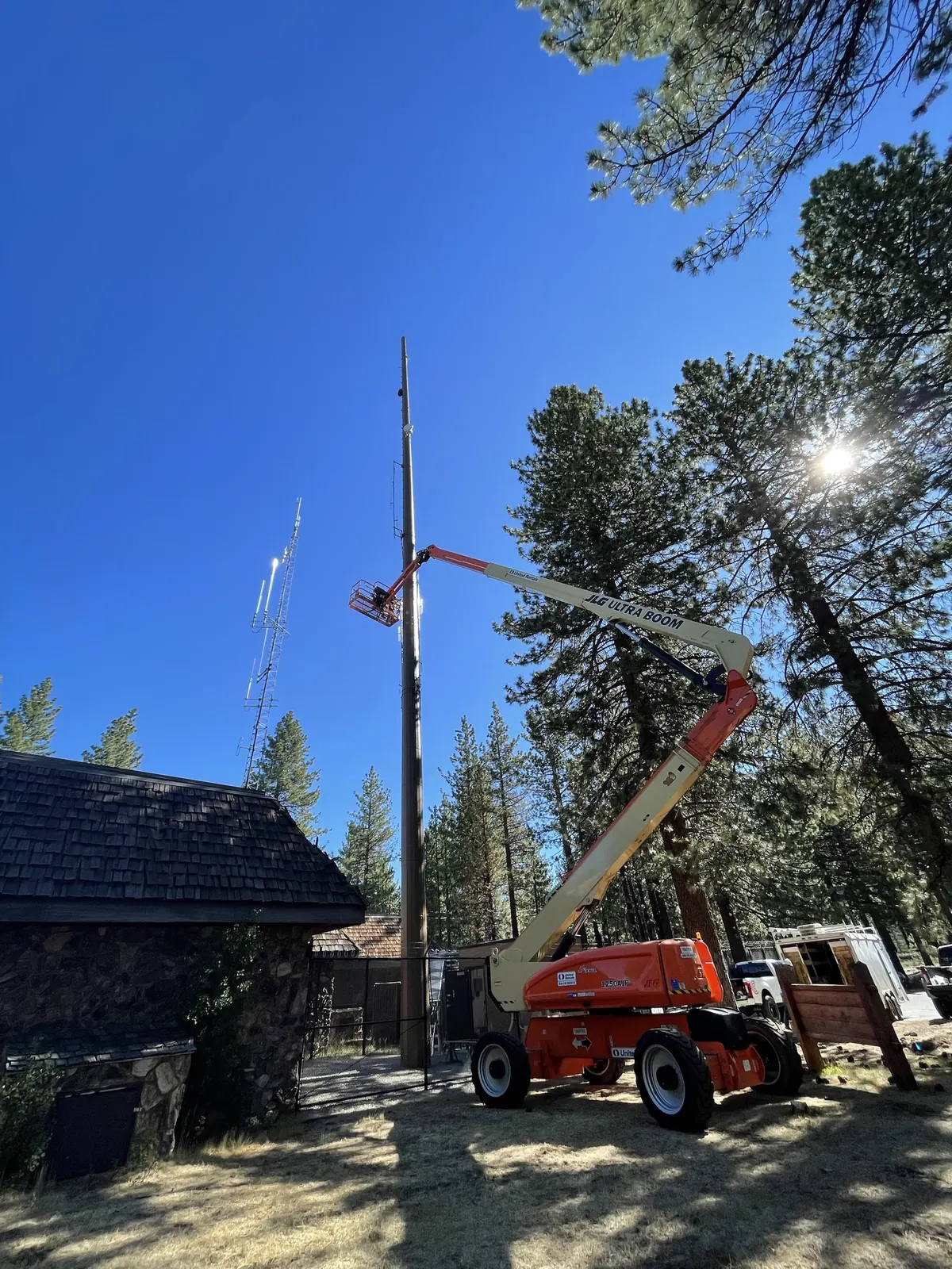 Boom lift working on a pole at a forest station