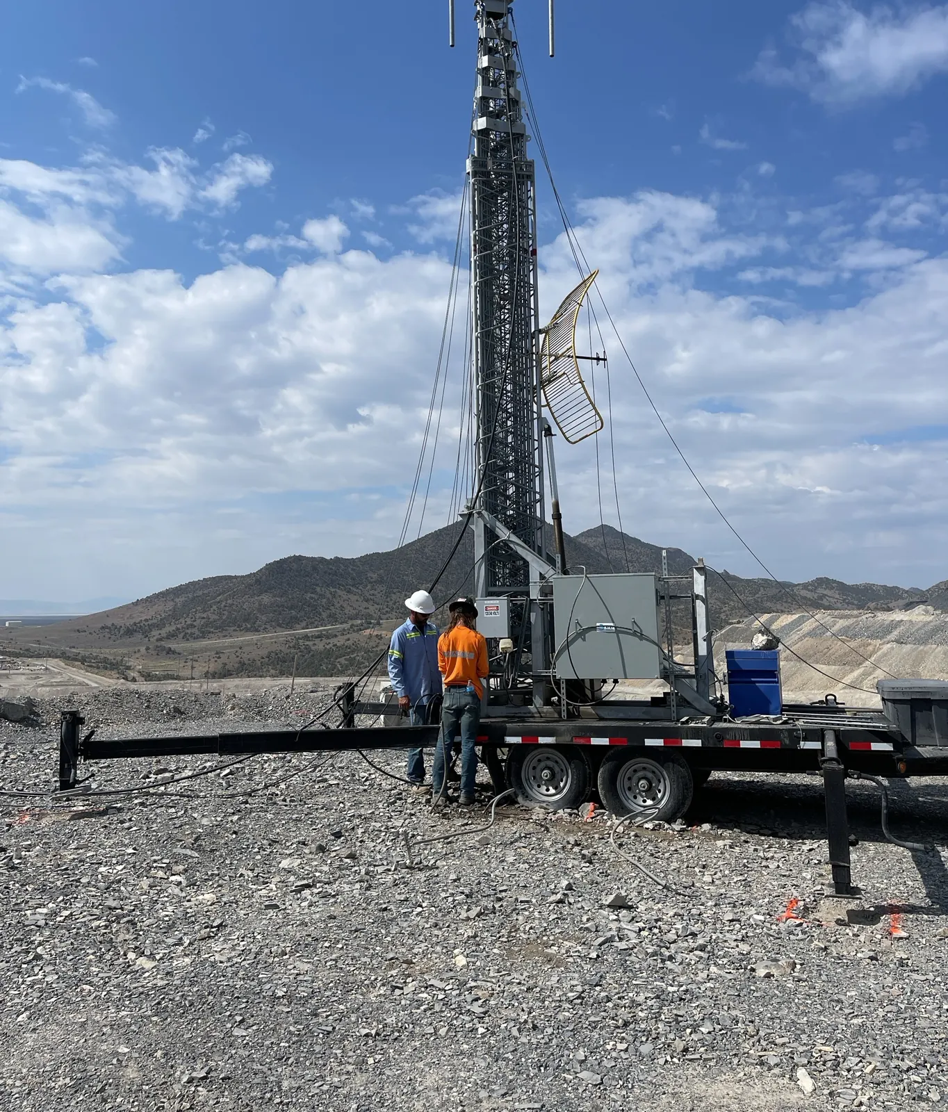 Crew setting up a cell-on-wheels trailer at a mine site