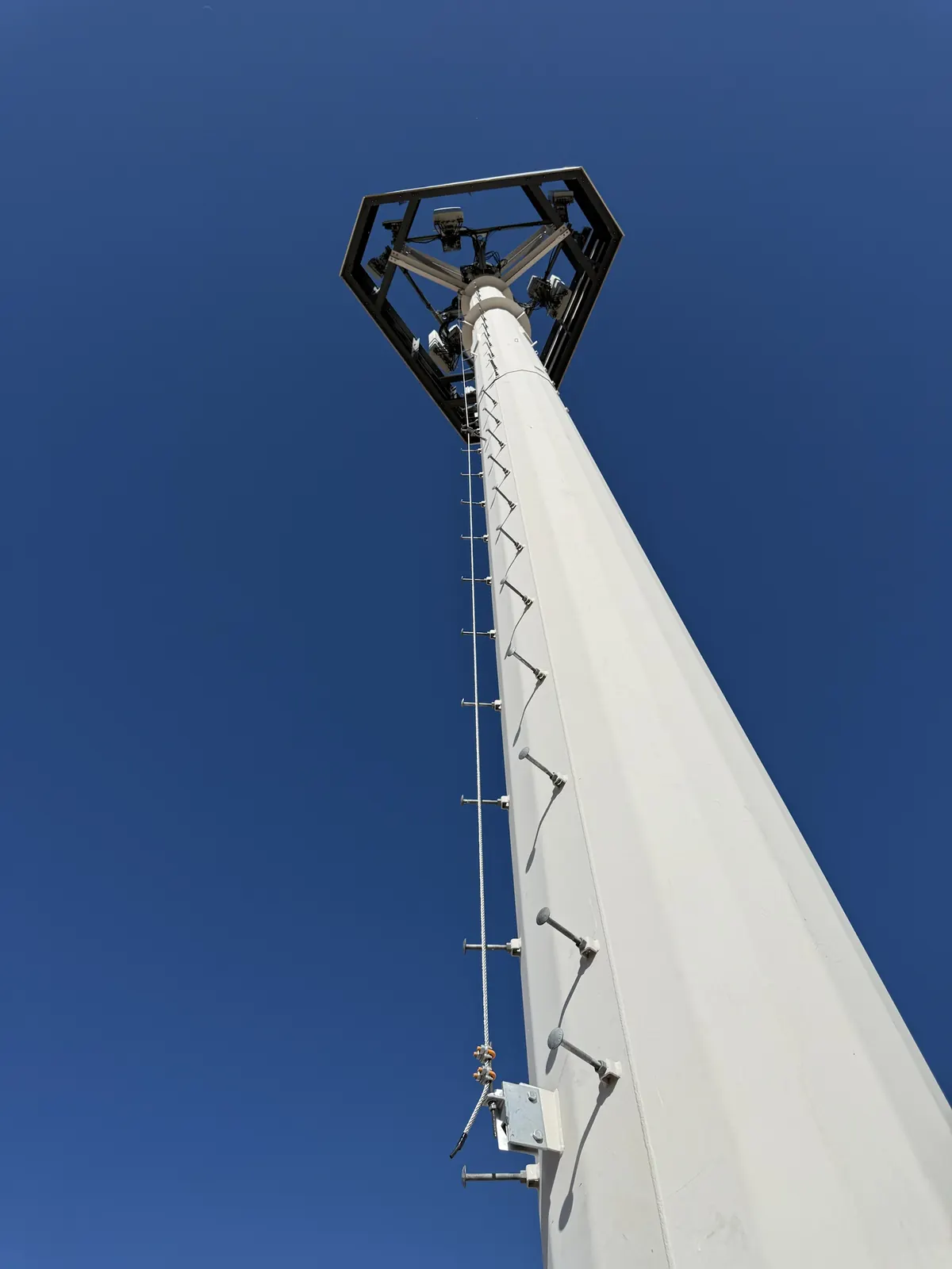 Looking up a monopole with platform and safety climb